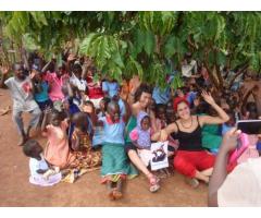Volunteer with  children in Uganda