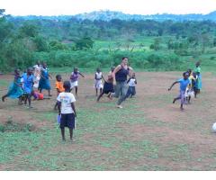 Volunteer with  children in Uganda